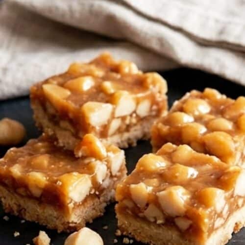 Caramel macadamia chaud versé dans un cadre de cuisson sur base de shortbread refroidi, vue de dessus