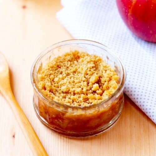 Dessert crumble aux pommes fait maison dans un bocal en verre avec décoration minimaliste et lumière naturelle