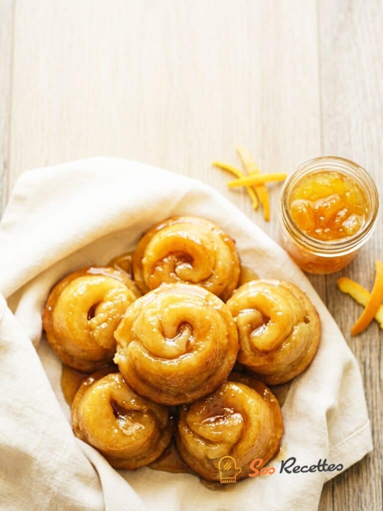 Roulés d'orange dorés cuits au four dans un moule à muffins